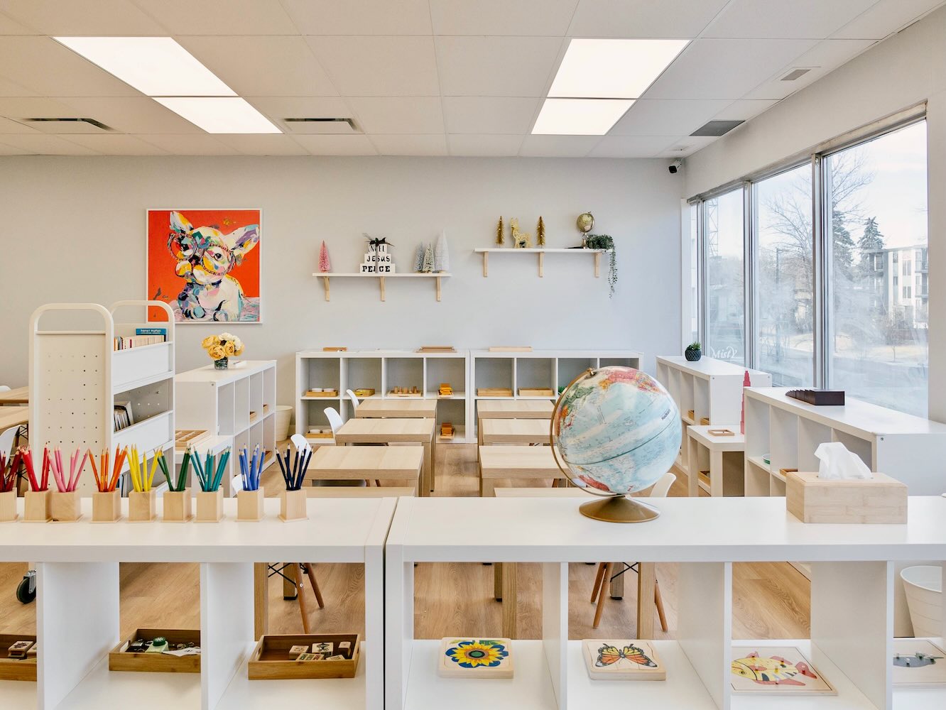 Bright Montessori classroom with learning materials and a globe at Mindful Playful daycare